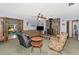 Cozy living room featuring a stone fireplace, ceiling fan, and comfortable seating arrangement at 2070 59Th St, Sarasota, FL 34243