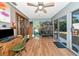 Bright sunroom featuring wood floors, sliding glass doors, and a ceiling fan for a cozy atmosphere at 2070 59Th St, Sarasota, FL 34243