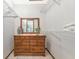 Walk-in closet with shelving units, mirror and wooden dresser for added storage at 2070 59Th St, Sarasota, FL 34243