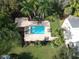 Aerial view of the backyard pool and brick paver patio, surrounded by tropical landscaping at 2224 Bahia Vista St # E6, Sarasota, FL 34239