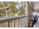 View from balcony overlooking lush greenery and mature trees in condo community at 2224 Bahia Vista St # E6, Sarasota, FL 34239