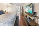 A cozy bedroom with hardwood floors, closet, and television at 2224 Bahia Vista St # E6, Sarasota, FL 34239