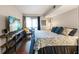 A bedroom with hardwood floors, a television, sliding glass doors and a relaxing seating area at 2224 Bahia Vista St # E6, Sarasota, FL 34239