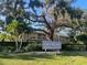 Sign for Cordova Gardens community with view of building exteriors and large trees at 2224 Bahia Vista St # E6, Sarasota, FL 34239