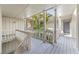Exterior shot of shared hallway on condo property with view of tropical plants at 2224 Bahia Vista St # E6, Sarasota, FL 34239