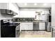 Updated kitchen featuring granite counters, stylish backsplash, stainless steel appliances, and ample cabinet space at 2224 Bahia Vista St # E6, Sarasota, FL 34239