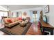 A well-lit living room featuring hardwood floors, comfortable seating, and access to a balcony at 2224 Bahia Vista St # E6, Sarasota, FL 34239