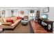 Cozy living room with hardwood floors, decorative wall art, and sliding doors leading to outdoor balcony at 2224 Bahia Vista St # E6, Sarasota, FL 34239