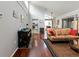 A cozy living room with hardwood floors, dining table, kitchen access, and natural lighting at 2224 Bahia Vista St # E6, Sarasota, FL 34239