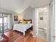 Spacious main bedroom features an ensuite bathroom, balcony access, and hardwood floors at 2224 Bahia Vista St # E6, Sarasota, FL 34239