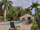 Community pool area with lounge chairs and tropical landscaping at 2224 Bahia Vista St # E6, Sarasota, FL 34239