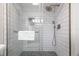 Modern shower featuring subway tile walls, hexagon tile floor, and glass door at 2224 Bahia Vista St # E6, Sarasota, FL 34239