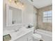 Bathroom featuring tub, updated tile surround, large mirror, and a white vanity at 2403 Aspinwall St, Sarasota, FL 34237