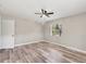Bedroom features light gray walls, wood floors, a ceiling fan and a window at 2403 Aspinwall St, Sarasota, FL 34237