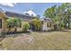 Inviting home exterior with manicured lawn, complemented by lush palm trees, and a charming front entrance at 2403 Aspinwall St, Sarasota, FL 34237