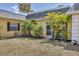 Charming home exterior featuring well-maintained landscaping with palm trees and a welcoming entrance at 2403 Aspinwall St, Sarasota, FL 34237
