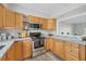 The kitchen features wood cabinets, stainless steel appliances, and an open layout at 2403 Aspinwall St, Sarasota, FL 34237