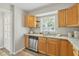 Cozy kitchen features stainless steel dishwasher and plenty of wooden cabinets at 2403 Aspinwall St, Sarasota, FL 34237