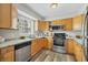 Bright kitchen with wood cabinets, stainless steel appliances and modern countertops at 2403 Aspinwall St, Sarasota, FL 34237