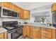 This lovely kitchen has stainless appliances, great counterspace, and a pass-through to the living area at 2403 Aspinwall St, Sarasota, FL 34237