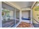 Enclosed lanai with brick floors, built-in seating, and screened windows at 2403 Aspinwall St, Sarasota, FL 34237
