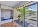 Enclosed lanai with brick floors and view of lush landscaping at 2403 Aspinwall St, Sarasota, FL 34237