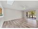 Bright living room boasting wood-look floors, a skylight, and sliding door access to the outdoors at 2403 Aspinwall St, Sarasota, FL 34237