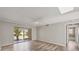 Living room featuring neutral walls, new floors, and a sliding glass door for natural light at 2403 Aspinwall St, Sarasota, FL 34237