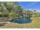 Scenic pond with a charming fountain feature surrounded by lush greenery and mature trees at 2403 Aspinwall St, Sarasota, FL 34237