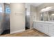 Elegant bathroom featuring double sinks, a large mirror, and a glass-enclosed walk-in shower at 2523 Dixon Ter, Port Charlotte, FL 33981
