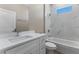 Bathroom featuring white marble tiling, modern fixtures, a bathtub, and a quartz vanity at 2523 Dixon Ter, Port Charlotte, FL 33981