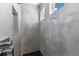 Modern shower featuring gray tiling, black honeycomb floor, and recessed shelving at 2523 Dixon Ter, Port Charlotte, FL 33981