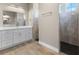 Elegant bathroom featuring double sinks, a large mirror, and a glass-enclosed walk-in shower at 2523 Dixon Ter, Port Charlotte, FL 33981