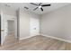 Bedroom with wood floors, ceiling fan, closet, and an en-suite bathroom at 2523 Dixon Ter, Port Charlotte, FL 33981