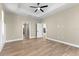 Neutral bedroom featuring decorative trim, hardwood floors, and multiple doorways at 2523 Dixon Ter, Port Charlotte, FL 33981