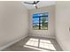 A sunlit bedroom with wood-look flooring and a view to the bright outdoors at 2523 Dixon Ter, Port Charlotte, FL 33981