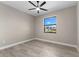 Bedroom featuring wood floors, a ceiling fan, and a window providing natural light at 2523 Dixon Ter, Port Charlotte, FL 33981