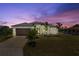 Well-manicured lawn with new landscaping and a painted exterior, as well as a two car garage at 2523 Dixon Ter, Port Charlotte, FL 33981