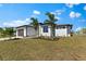 Exterior of home features a well-manicured lawn and a two-car garage at 2523 Dixon Ter, Port Charlotte, FL 33981