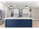 Beautiful kitchen featuring a large island, stainless steel appliances, white cabinetry, and stylish pendant lighting at 2523 Dixon Ter, Port Charlotte, FL 33981