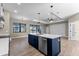 Open kitchen with blue island, stainless appliances, pendant lighting, and a view to the pool at 2523 Dixon Ter, Port Charlotte, FL 33981