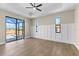 Living room featuring wood floors, board and batten accents, tray ceilings, and view of the pool at 2523 Dixon Ter, Port Charlotte, FL 33981