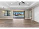 Bright living room with tile flooring, sliding glass doors, and a ceiling fan, offering great natural light at 2523 Dixon Ter, Port Charlotte, FL 33981