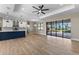 Spacious living area with a modern kitchen, tile floors, and sliding doors to the backyard pool area at 2523 Dixon Ter, Port Charlotte, FL 33981