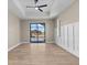 Living room with views of the pool and lanai, wood floors, board and batten accents, and a ceiling fan at 2523 Dixon Ter, Port Charlotte, FL 33981