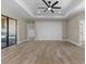 Spacious living room featuring a modern accent wall, neutral paint, and views of the outdoor kitchen area at 2523 Dixon Ter, Port Charlotte, FL 33981