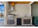 Outdoor kitchen with stainless steel grill, beverage cooler, sink, and stone accents by the pool at 2523 Dixon Ter, Port Charlotte, FL 33981