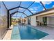 A beautiful pool under a screened enclosure with an outdoor grill and kitchen at 2523 Dixon Ter, Port Charlotte, FL 33981