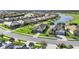 Aerial view of homes in a lakeside community featuring well-manicured lawns and a golf course at 25325 Longmeadow Dr, Punta Gorda, FL 33955