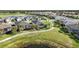 Scenic aerial view of homes boasting screened lanais, picturesque landscaping, and a tranquil pond at 25325 Longmeadow Dr, Punta Gorda, FL 33955